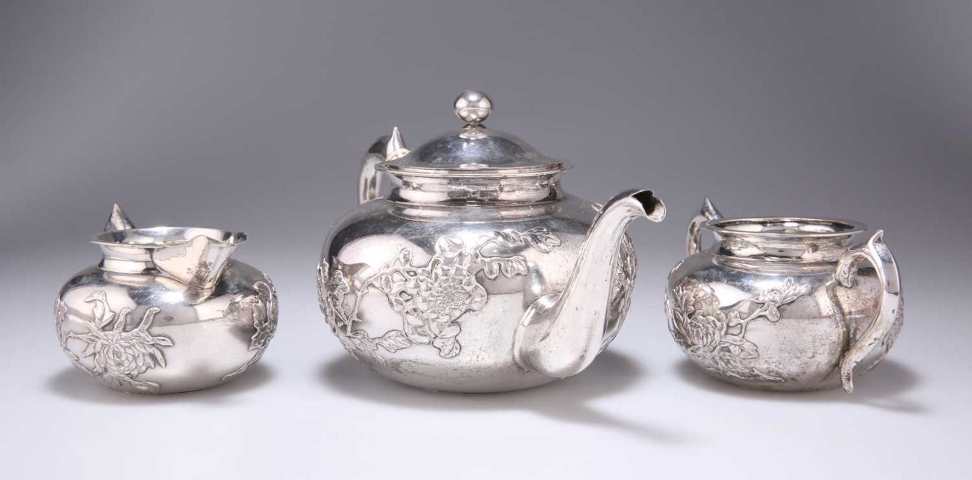 A CHINESE SILVER THREE-PIECE TEA SERVICE