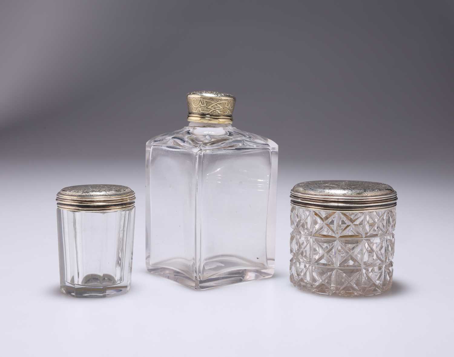 THREE WILLIAM IV SILVER-GILT TOPPED JARS / BOTTLES