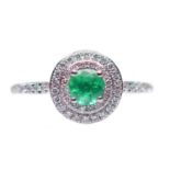 A PLATINUM EMERALD AND DIAMOND CLUSTER RING