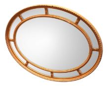 A 19TH CENTURY OVAL WALL MIRROR
