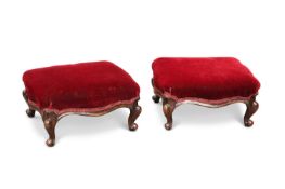 A PAIR OF VICTORIAN WALNUT AND UPHOLSTERED FOOTSTOOLS