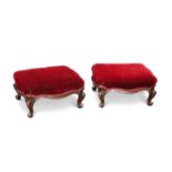 A PAIR OF VICTORIAN WALNUT AND UPHOLSTERED FOOTSTOOLS