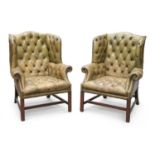 A PAIR OF GEORGIAN STYLE GREEN LEATHER AND MAHOGANY WING-BACK ARMCHAIRS