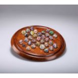 TREEN: A LATE VICTORIAN MAHOGANY SOLITAIRE BOARD AND MARBLES