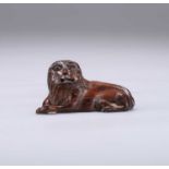 TREEN: AN EARLY 19TH CENTURY CARVING OF A RECUMBENT LION