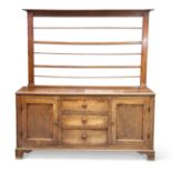 A GEORGE III OAK DRESSER AND RACK