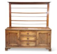 A GEORGE III OAK DRESSER AND RACK