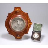 AN EDWARDIAN INLAID WALNUT BAROMETER AND AN 8-DAY TRAVEL CLOCK