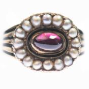 A GEORGIAN GARNET AND SEED PEARL MOURNING RING