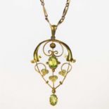 AN ART NOUVEAU PERIDOT PENDANT ON CHAIN