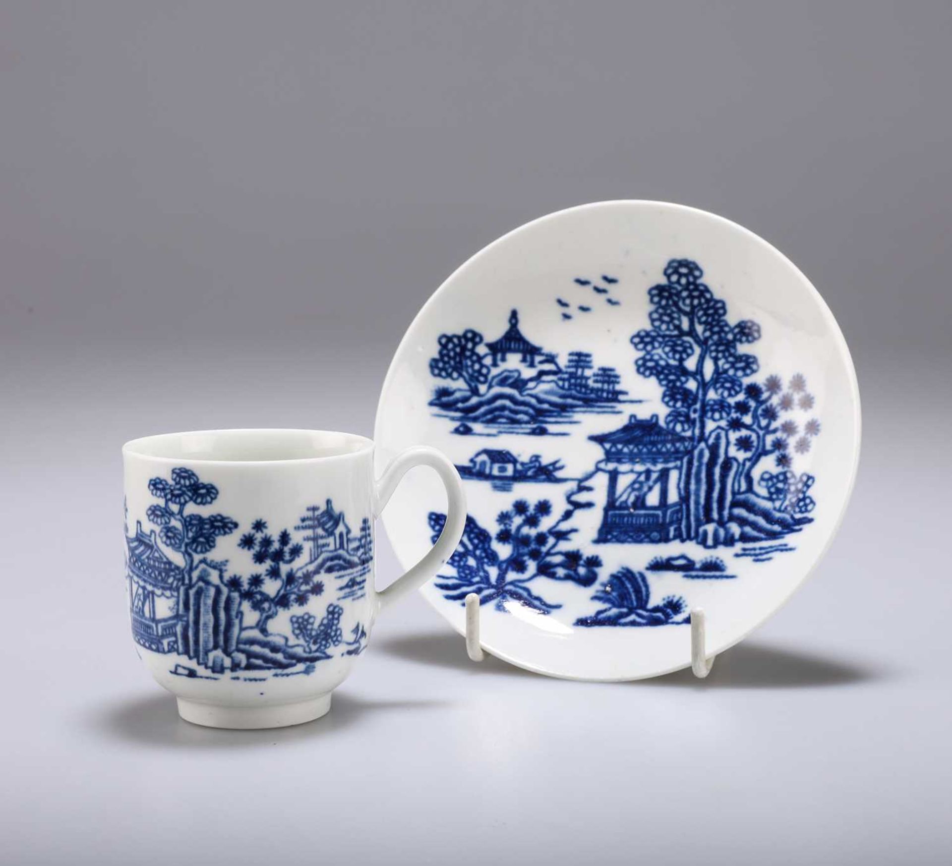 A WORCESTER BLUE AND WHITE PORCELAIN COFFEE CUP AND SAUCER