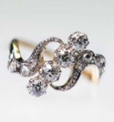 AN EARLY 20TH CENTURY DIAMOND CROSSOVER RING