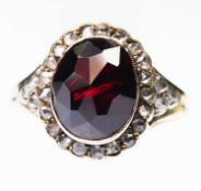 A GARNET AND DIAMOND CLUSTER RING