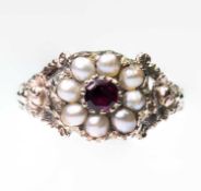 AN EARLY VICTORIAN GARNET AND SPLIT PEARL CLUSTER RING