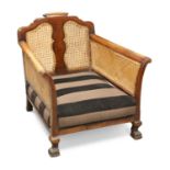 A WALNUT AND CANEWORK BERGÈRE CHAIR, CIRCA 1920-30