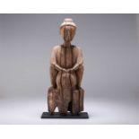 A CARVED WOODEN FIGURE