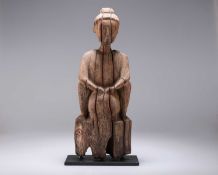 A CARVED WOODEN FIGURE
