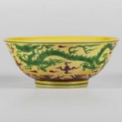 A CHINESE YELLOW GROUND GREEN AND AUBERGINE ENAMELLED 'DRAGON' BOWL