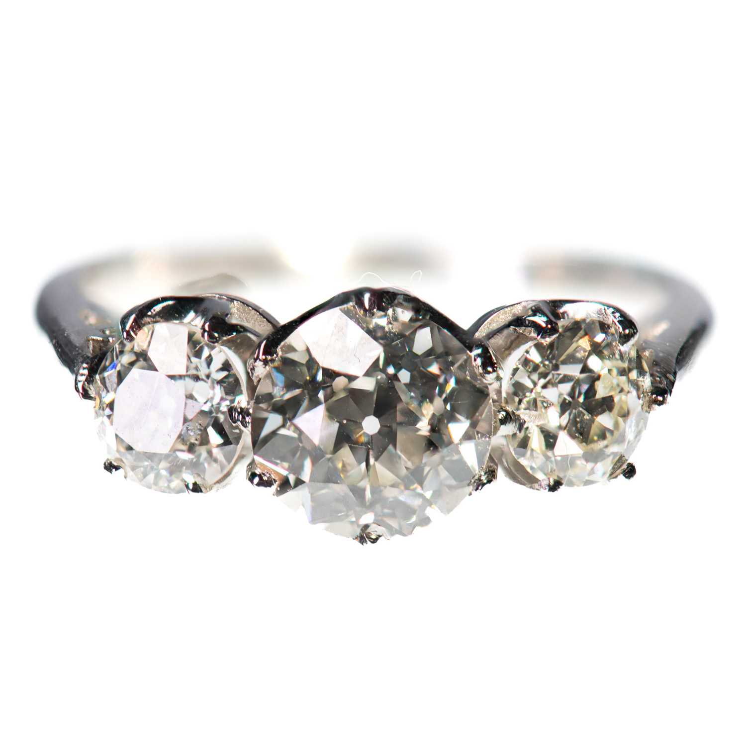 A PLATINUM DIAMOND THREE STONE RING