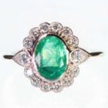 AN 18 CARAT GOLD EMERALD AND DIAMOND CLUSTER RING