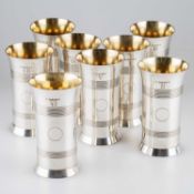 SHOOTING INTEREST: A SET OF EIGHT SILVER BEAKERS, IN THE FORM OF ARTILLERY SHELL CASES