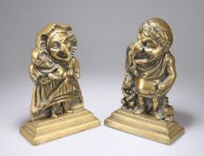 A PAIR OF VICTORIAN BRASS PUNCH AND JUDY DOOR STOPS