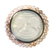 A LATE 19TH CENTURY MOONSTONE AND SEED PEARL MAN IN THE MOON BROOCH