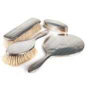 A GEORGE V SILVER FOUR-PIECE DRESSING TABLE SET