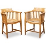 A PAIR OF ARTS AND CRAFTS OAK AND LEATHER TUB CHAIRS