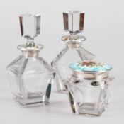 A SET OF THREE SPANISH SILVER, ENAMEL AND GLASS DRESSING TABLE JARS/BOTTLES