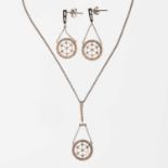 A DIAMOND PENDANT AND EARRING SET