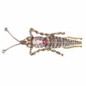 AN EARLY 20TH CENTURY DIAMOND AND RUBY NOVELTY CRICKET BROOCH
