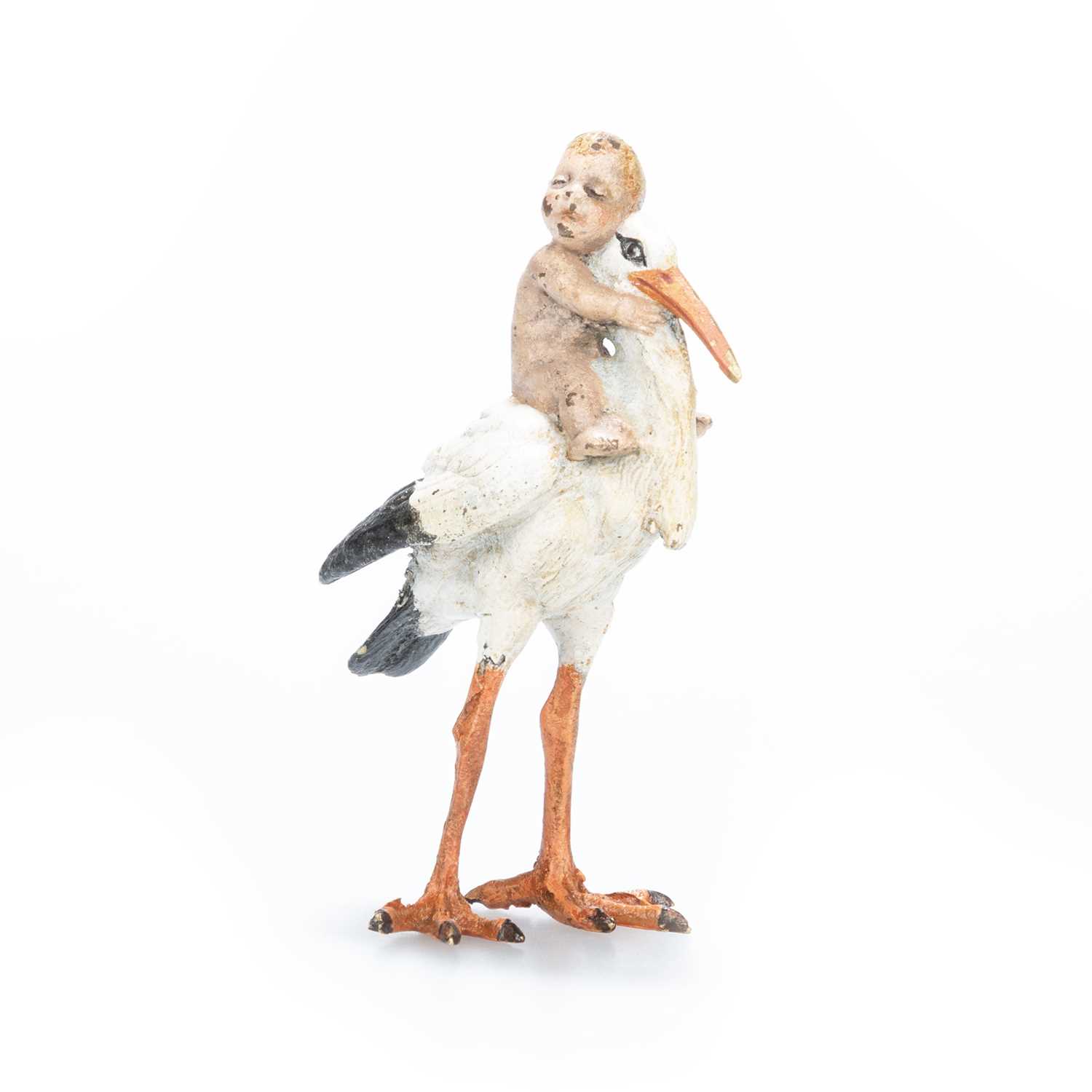 A COLD PAINTED BRONZE MODEL OF A BABY-BEARING STORK