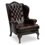 A GEORGIAN STYLE LEATHER WING-BACK ARMCHAIR