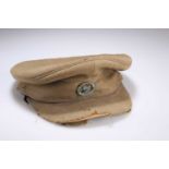 AN OFFICERS SERVICE DRESS PEAK CAP WITH LRDG BADGE