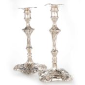 A PAIR OF EARLY GEORGE III CAST SILVER CANDLESTICKS