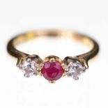 AN 18 CARAT GOLD RUBY AND DIAMOND THREE STONE RING