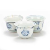 THREE SMALL CHINESE BLUE AND WHITE BUDDHIST SYMBOLS WINE CUPS, MING 15TH CENTURY