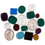 EIGHTEEN VARIOUS 19TH CENTURY CLEAR AND COLOURED PASTE INTAGLIO SEALS