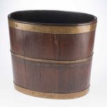 A GEORGE III BRASS-BOUND MAHOGANY OVAL PEAT BUCKET