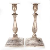 A PAIR OF 18TH CENTURY CAST SILVER CANDLESTICKS