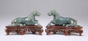 A PAIR OF CHINESE SPINACH JADE MODELS OF RECUMBENT HORSES