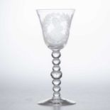 A DUTCH-ENGRAVED NEWCASTLE LIGHT BALUSTER WINE GLASS, MID-18TH CENTURY