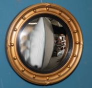 A REGENCY STYLE GILT-COMPOSITION CONVEX WALL MIRROR, LATE 19TH CENTURY