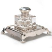 AN EDWARDIAN SILVER AND GLASS INKWELL