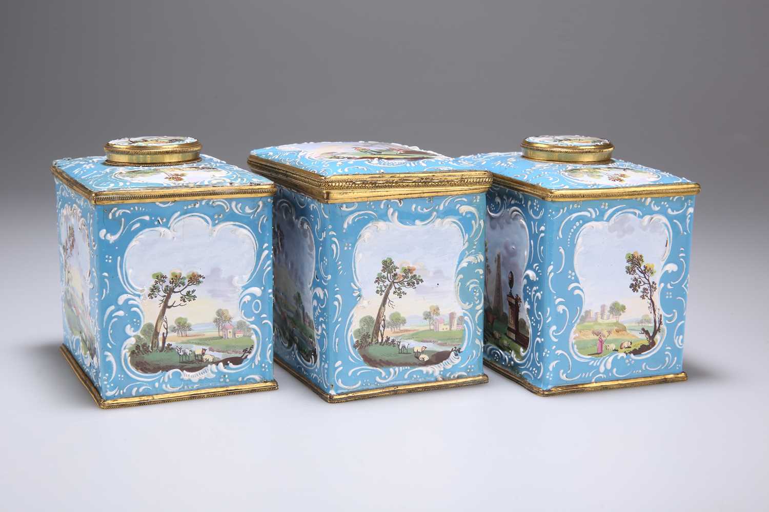 A PAIR OF ENGLISH ENAMEL TEA CADDIES AND A SUGAR BOX, SOUTH STAFFORDSHIRE, CIRCA 1770