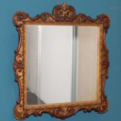 A 19TH CENTURY CARVED AND GILDED WALL MIRROR