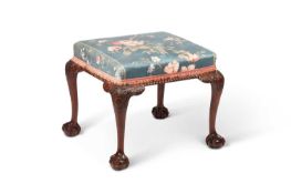 A GEORGE II IRISH STYLE CARVED MAHOGANY AND UPHOLSTERED STOOL