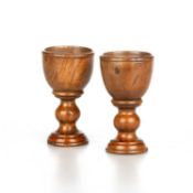 A PAIR OF 19TH CENTURY TREEN EGG CUPS