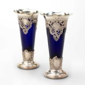 A PAIR OF EDWARDIAN SILVER AND BLUE GLASS VASES